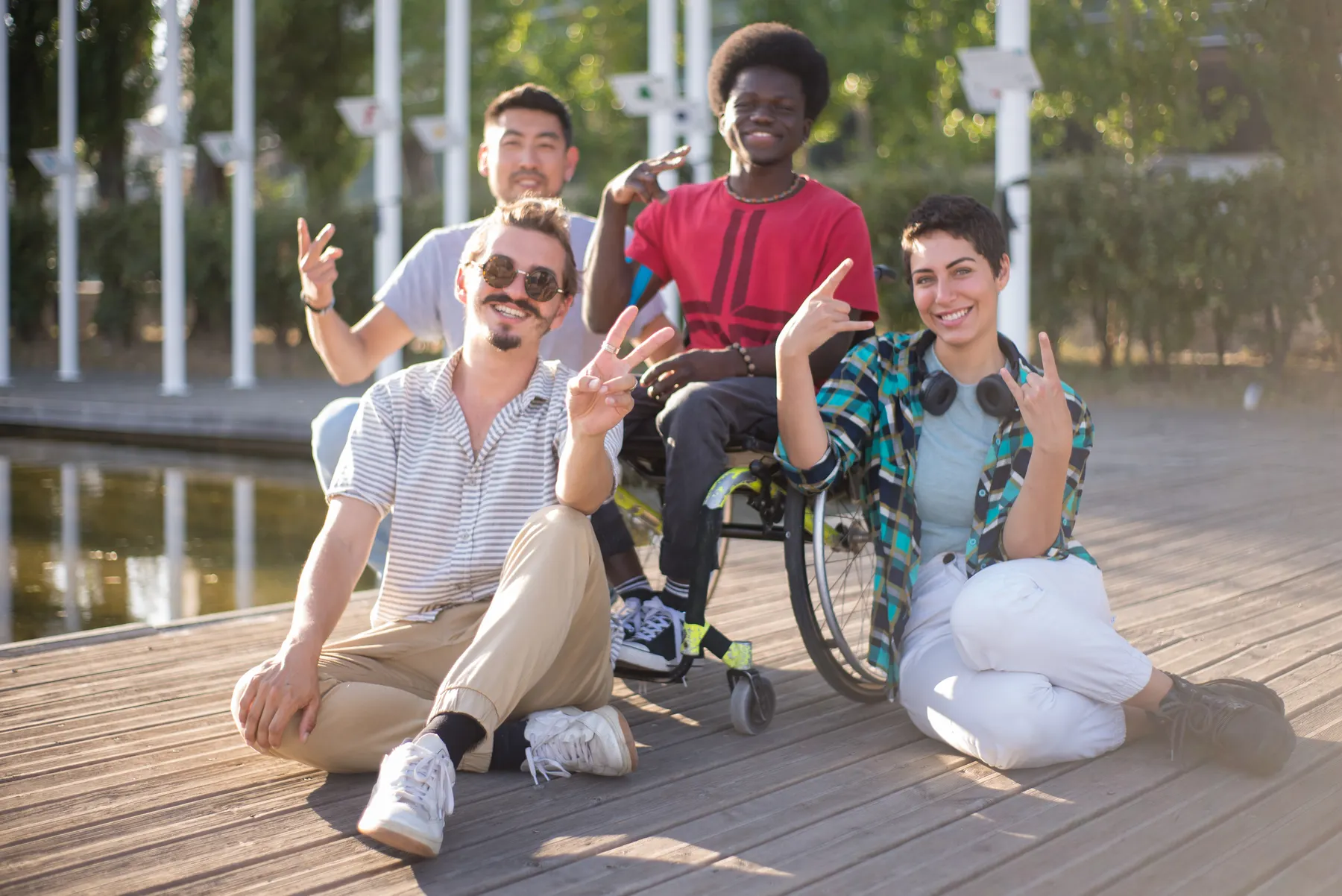 A joyful group of friends gathered with a wheelchair user